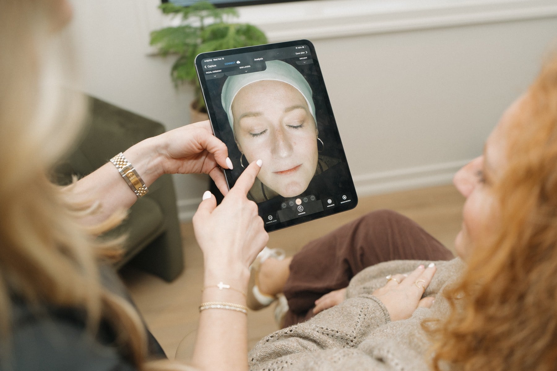 A provider reviewing a client's skin analysis on screen at Illumatox in Neenah