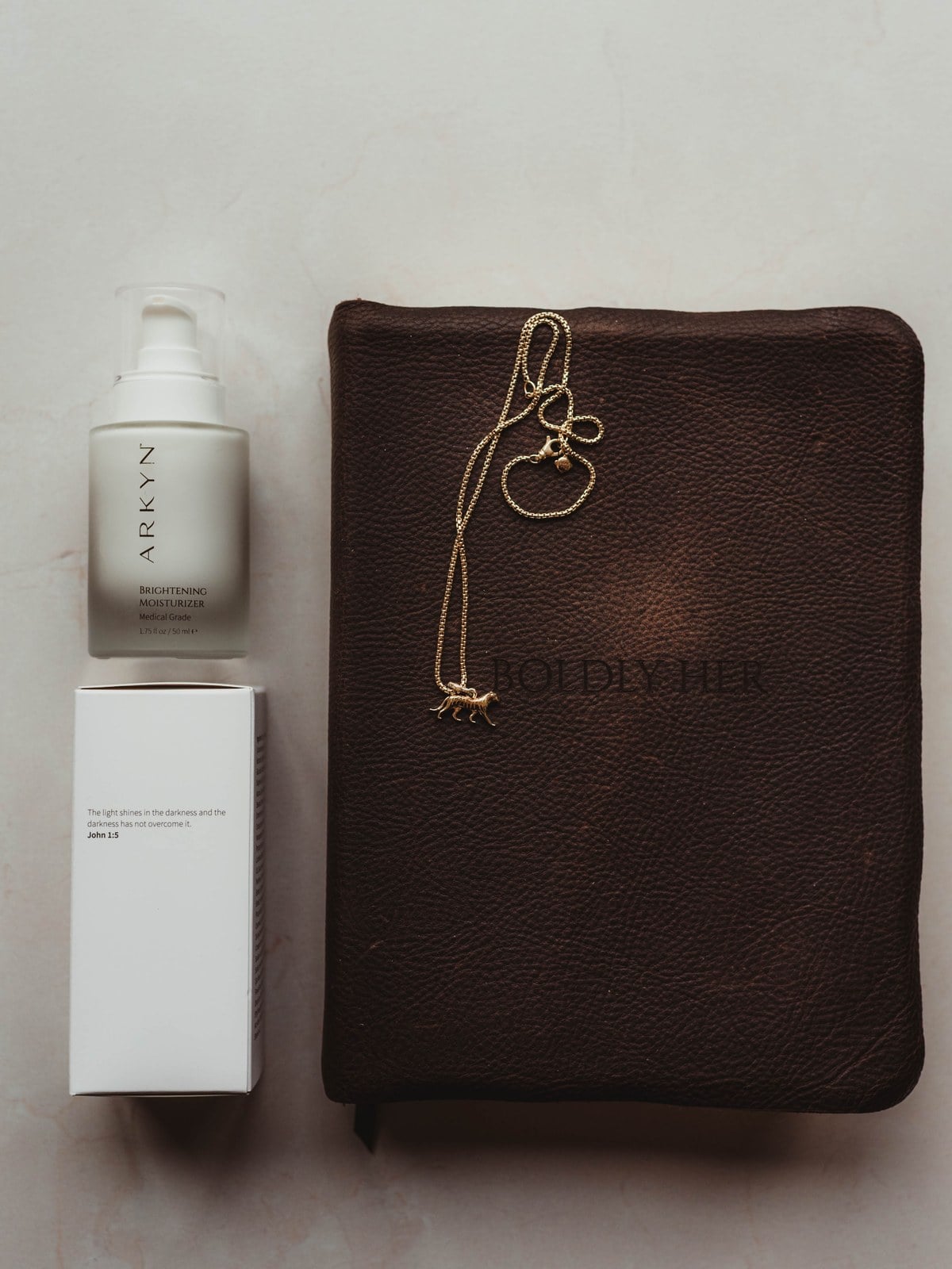 An Arkyn product photographed beside a leather Bible with a gold cross bookmark