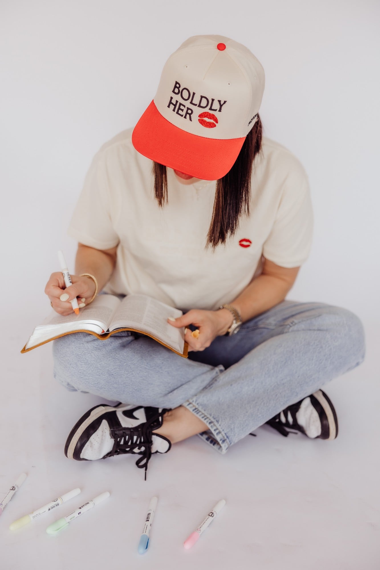 A Boldly Her cap and tee from the Illumatox brand collection