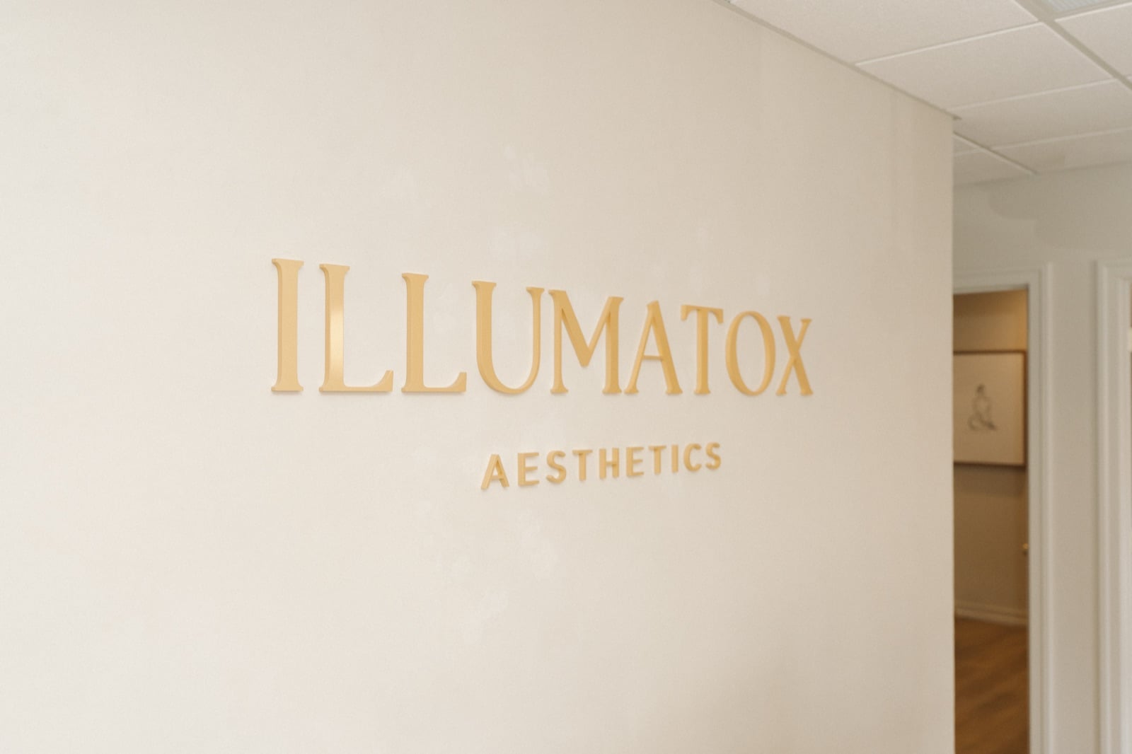 The Illumatox Aesthetics wall lettering inside the studio at 704 Main St, Neenah