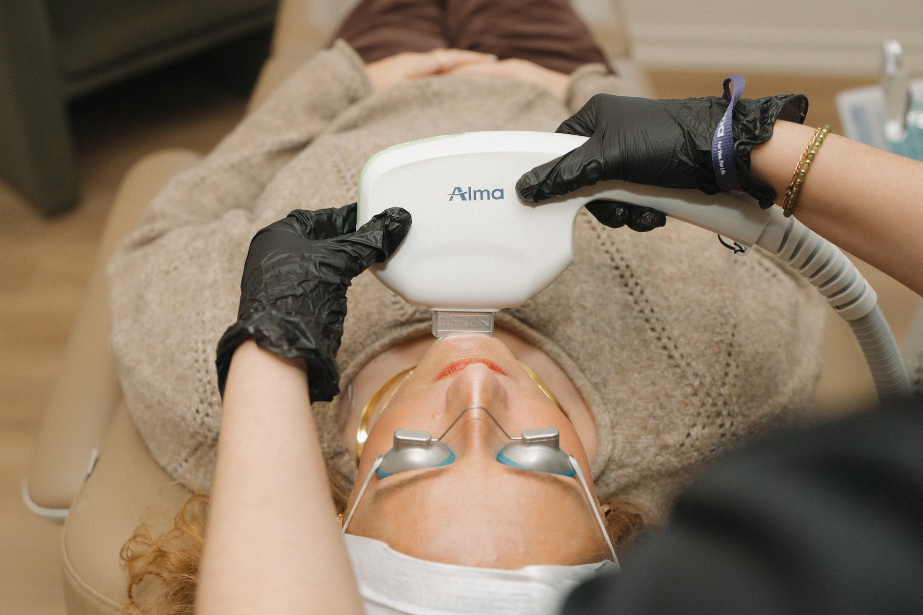 Protective eye shields in place before a light-based treatment at Illumatox in Neenah