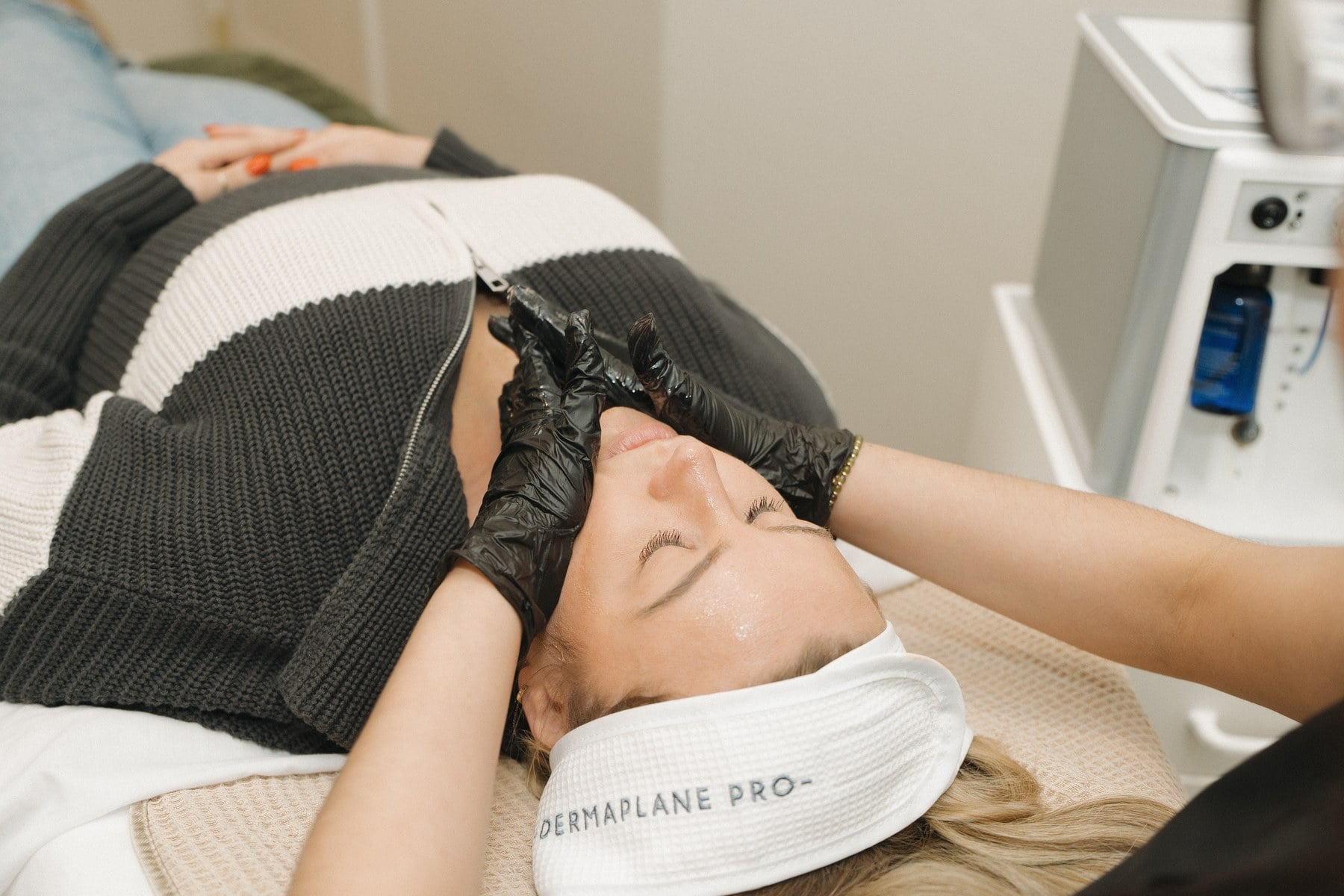 A client in a treatment headband during a facial at Illumatox Aesthetic Studio in Neenah
