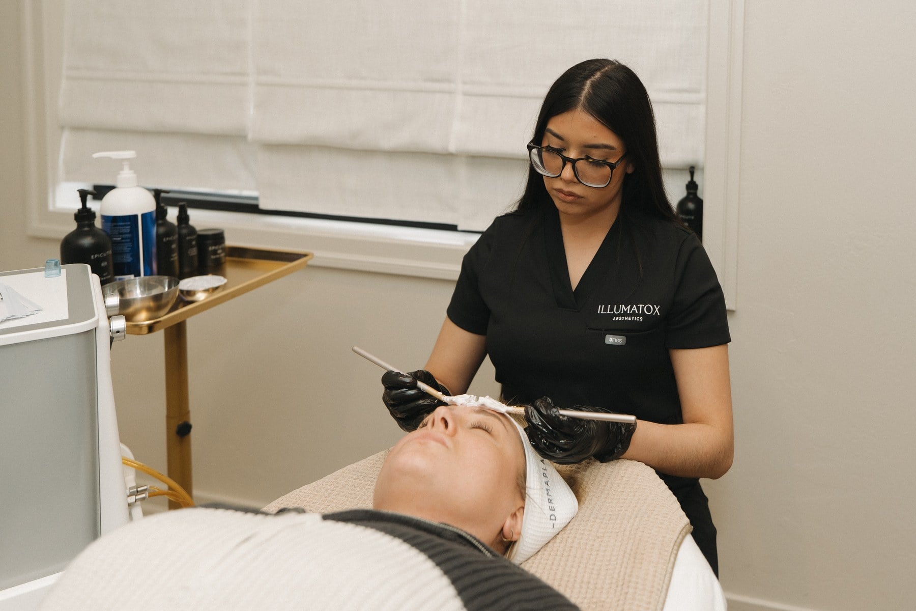 A treatment mask being applied during a facial at Illumatox Aesthetic Studio in Neenah