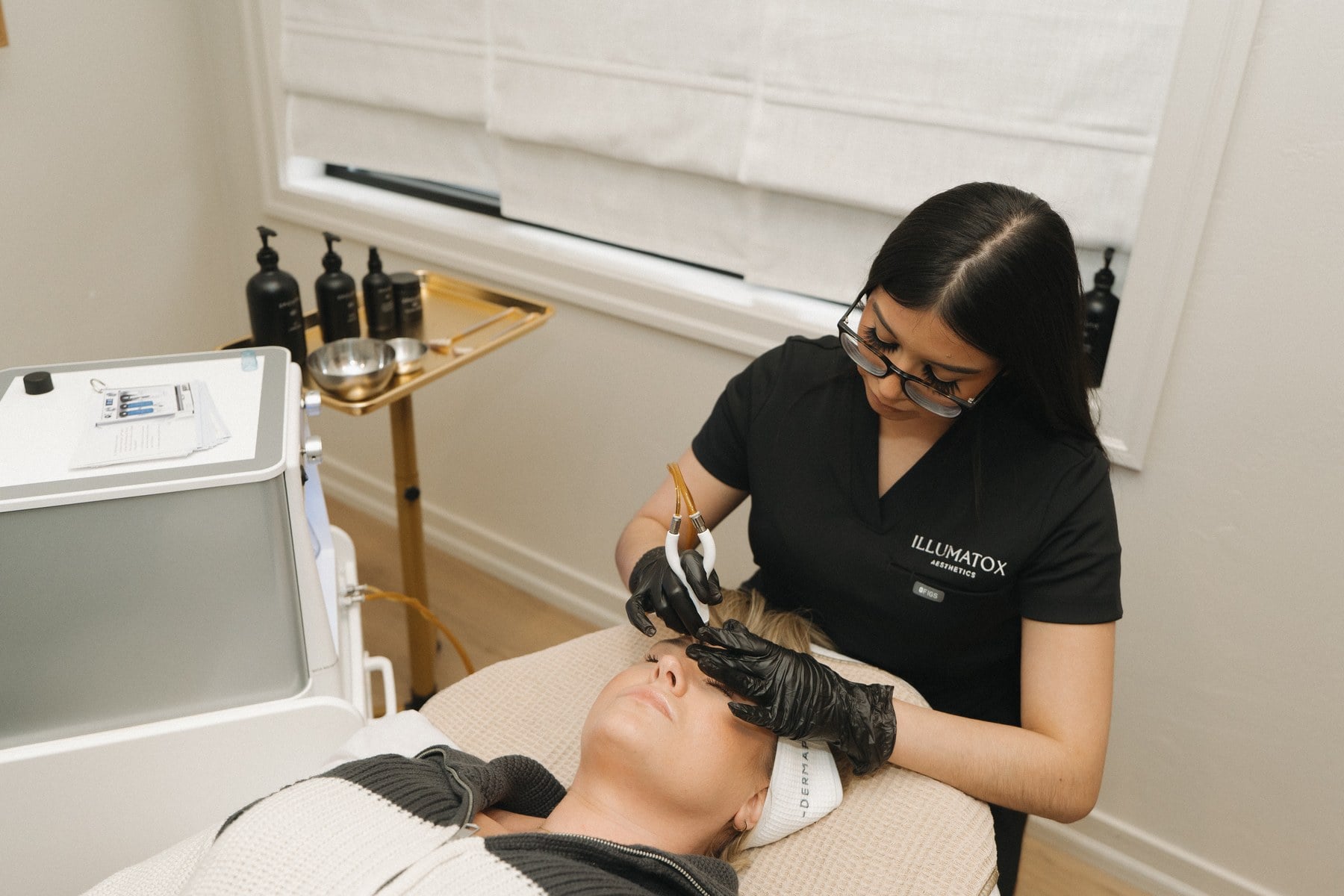 The Glo2Facial handpiece and tubing in a treatment room at Illumatox in Neenah
